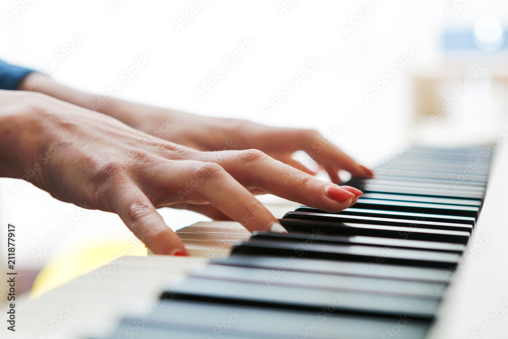 Close up of pianists hand playing piano. Shallow deep of field.