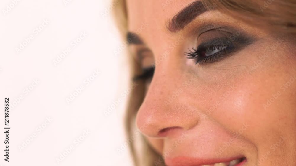 Woman face with smoky eyes make up looking side close up. Portrait pretty woman with bright makeup. Beautiful woman with gray eyes . Woman face with smoky eyes make up looking side close up. Portrait pretty woman with bright makeup. Beautiful woman with gray eyes .