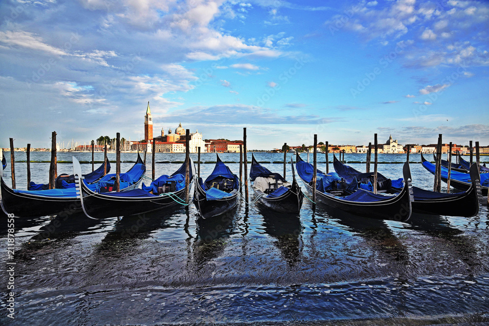 Gondolas side by side near the shore in Venice, Italy