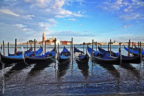 Gondolas side by side near the shore in Venice, Italy