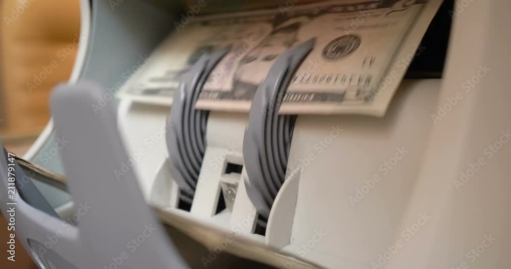 Counting US Dollars Banknotes On Currency Counter Machine Counting US Dollars Banknotes On Currency Counter Machine