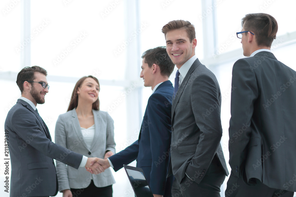 Business handshake. Two cheerful businessman shaking hands in o Business handshake. Two cheerful businessman shaking hands in o
