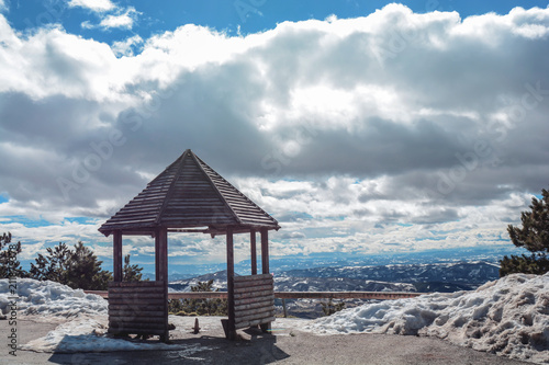 Viewpoint on mountain with snow and cloudy sky with view on valley © bennian_1