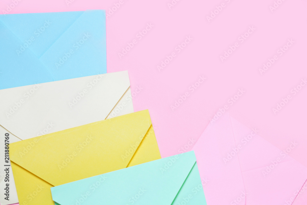 Frame from colorful envelopes on pink table top view. Frame from colorful envelopes on pink table top view.