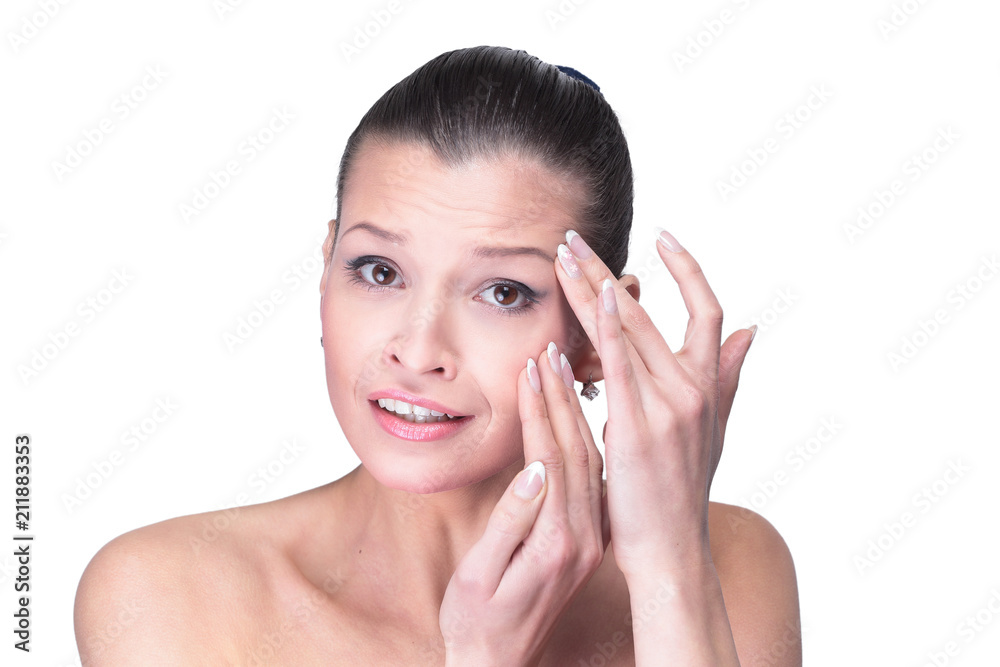 Young woman touching her face isolated on white background