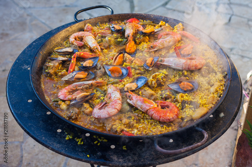 Traditional Spanish paella with seafood and chicken in a pan