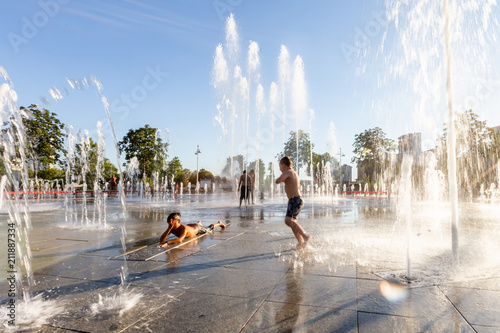Unidentified Kids playing in the fountain in city park
