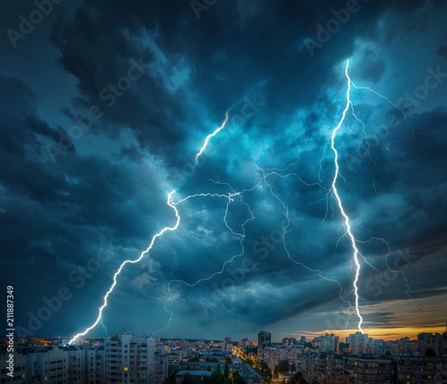 Lightning thunderstorm flash over the night city. 