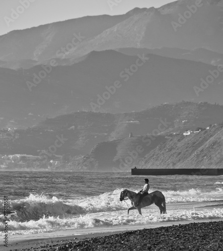 Granada, Spain; January 21, 2018: Boy riding a horse on the seashore