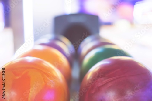 Multicolored bowling balls arranged in a row. Vivid colors. Summer day 