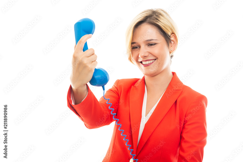 Young pretty business woman looking at blue receiver. Young pretty business woman looking at blue receiver.