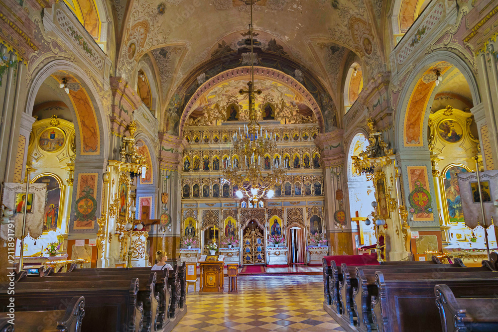 A very beautiful church inside with an altar set with icons, with painted holy walls and frescoes and paintings on the ceiling and pillars.