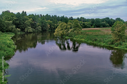 Transparent water surface, dividing the green forest zone into two banks
