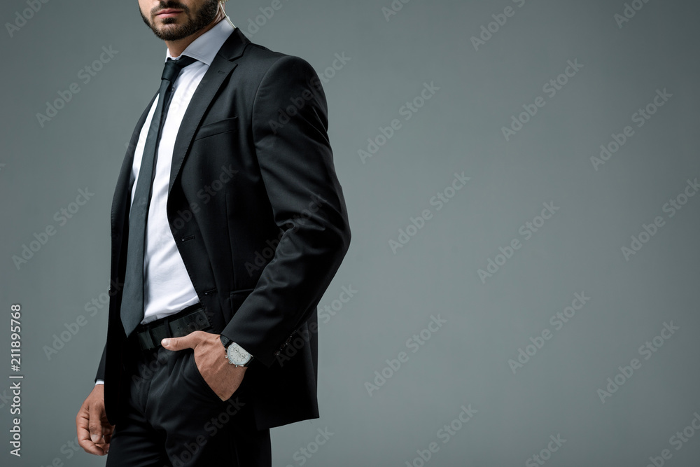 cropped image of security guard with security earpiece standing isolated on grey cropped image of security guard with security earpiece standing isolated on grey