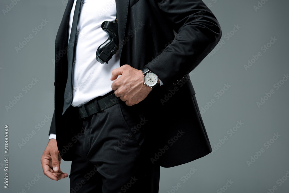 cropped image of security guard standing with gun isolated on grey