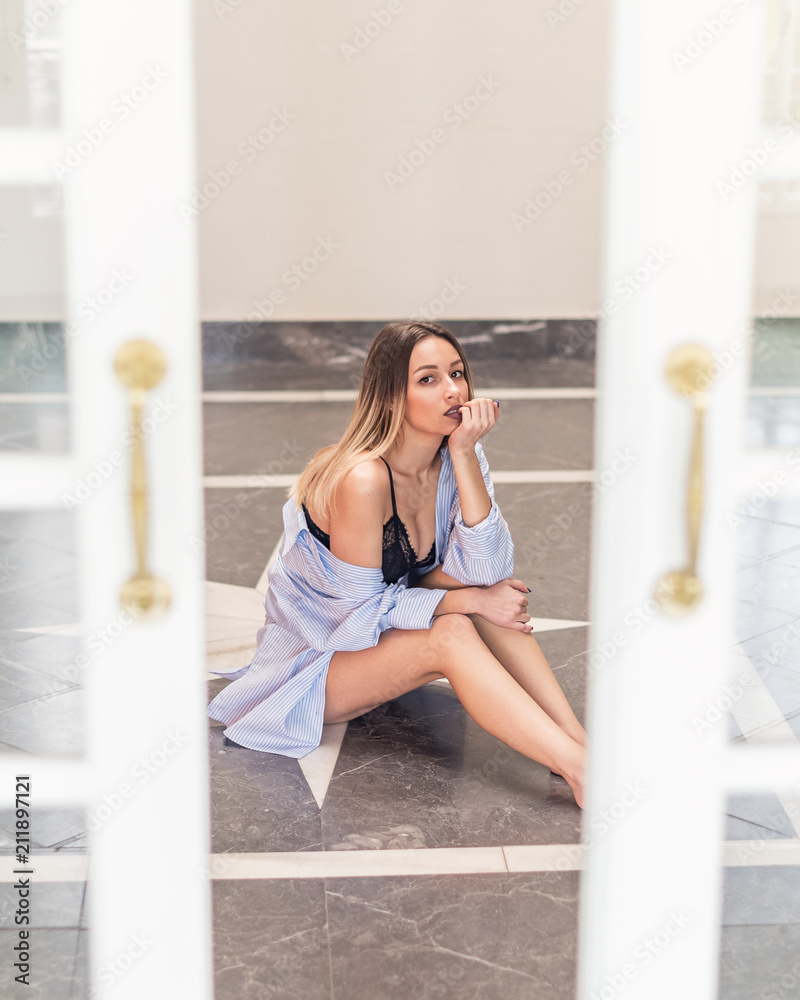 Woman in lingerie and shirt sitting on floor Woman in lingerie and shirt sitting on floor