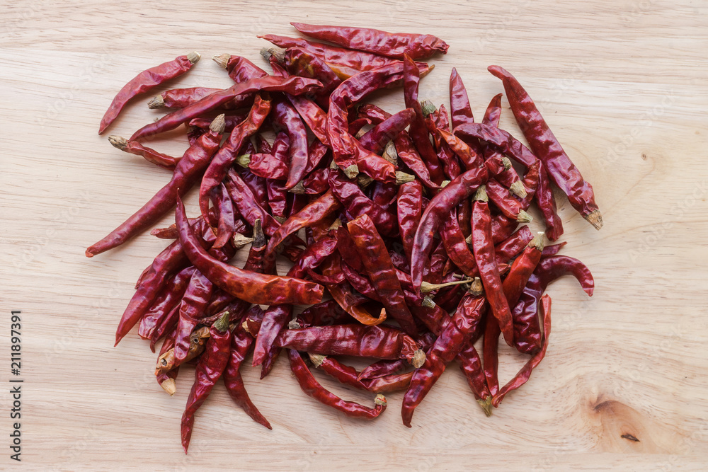 close up of dry chili on wooden background close up of dry chili on wooden background