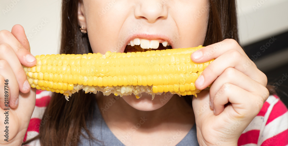 Beautiful girl gnaws / bites corn Beautiful girl gnaws / bites corn