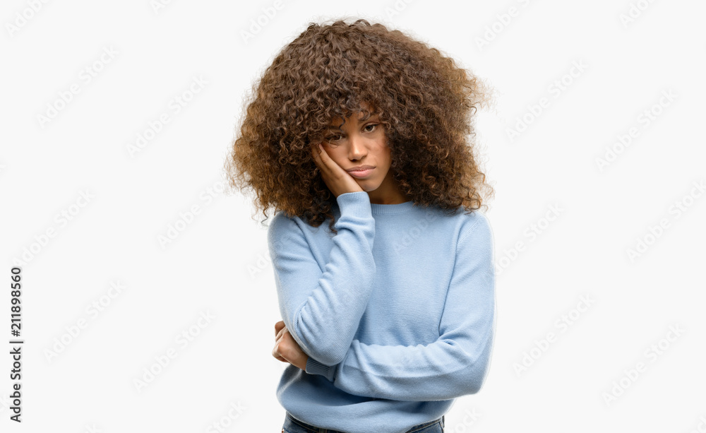African american woman wearing a sweater thinking looking tired and bored with depression problems with crossed arms. African american woman wearing a sweater thinking looking tired and bored with depression problems with crossed arms.