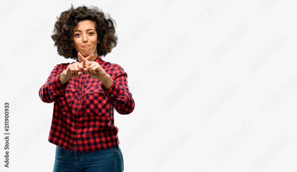 Beautiful arab woman annoyed with bad attitude making stop sign with hand, saying no, expressing security, defense or restriction, maybe pushing Beautiful arab woman annoyed with bad attitude making stop sign with hand, saying no, expressing security, defense or restriction, maybe pushing