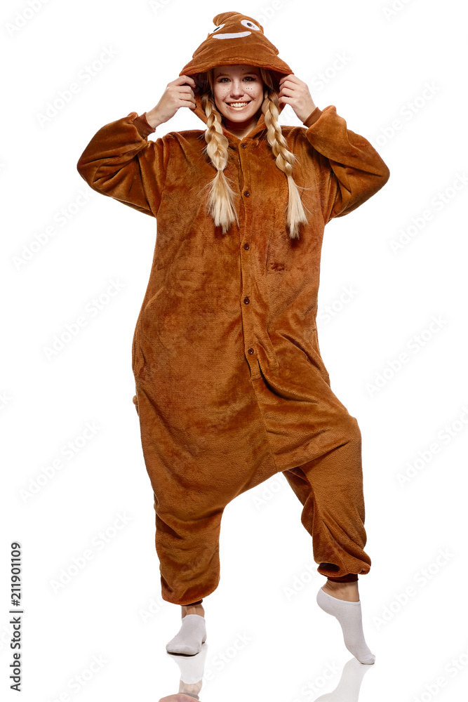 A pretty girl in a funny brown kigurumi featuring poop emoji. The  attractive blonde having fun,