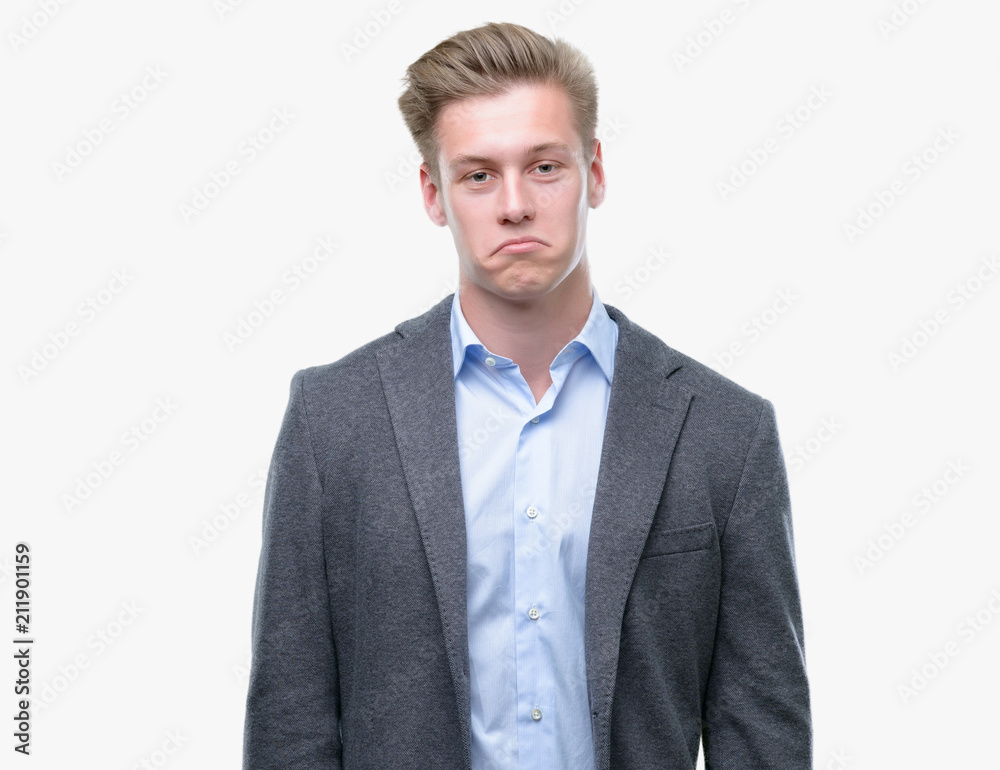Young handsome blond business man depressed and worry for distress, crying angry and afraid. Sad expression. Young handsome blond business man depressed and worry for distress, crying angry and afraid. Sad expression.