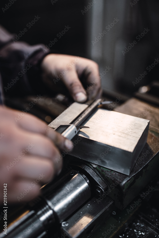 Metallurgy heavy industry. Factory for production of special industrial tools. Worker hands close up. Metallurgy heavy industry. Factory for production of special industrial tools. Worker hands close up.