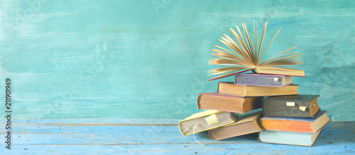 Open book on a stack of books. Reading, learning, education concept, panorama,good copy space.