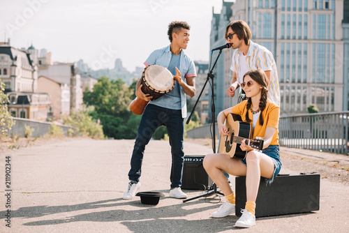 Team of young multiracial friends having fun and performing in urban environment