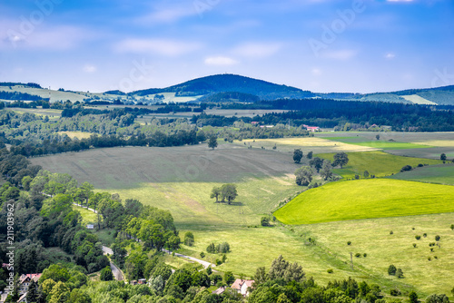 Farm field in green valley in mountains, landscape, Sudety in Poland