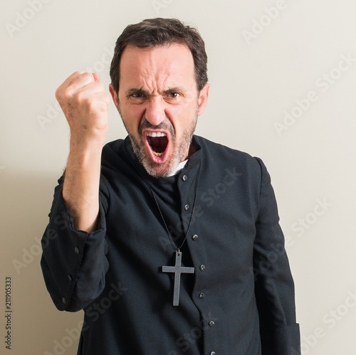 Senior priest religion man annoyed and frustrated shouting with anger, crazy and yelling with raised hand, anger concept