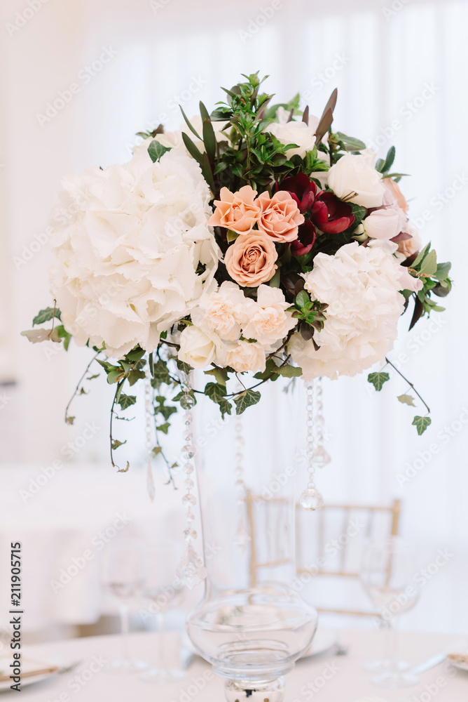 Magnificent, volume bouquets of flowers in high glass vases