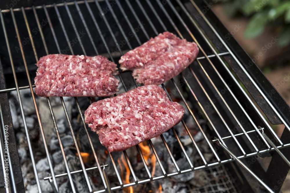 Raw Sausages cook on the grill Raw Sausages cook on the grill