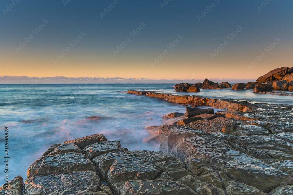 Sunrise and Rock Platform by the Sea