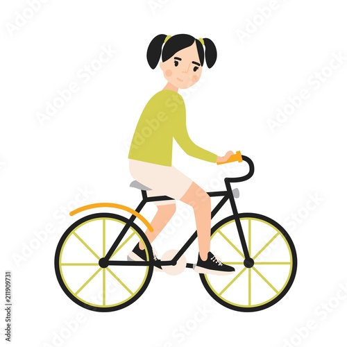 Young cute smiling girl riding bicycle