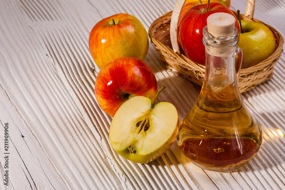 apple vinegar on a wooden rustic background apple vinegar on a wooden rustic background