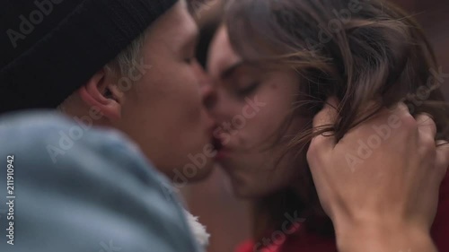 passionate kiss of a young couple close-up.