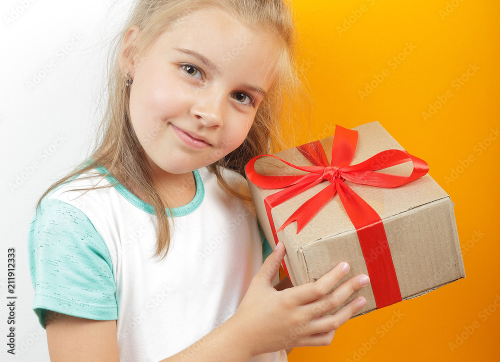 Gifts, shopping and present - Gift box is tied bow in the beautiful girl's hands wooden background Gifts, shopping and present - Gift box is tied bow in the beautiful girl's hands wooden background