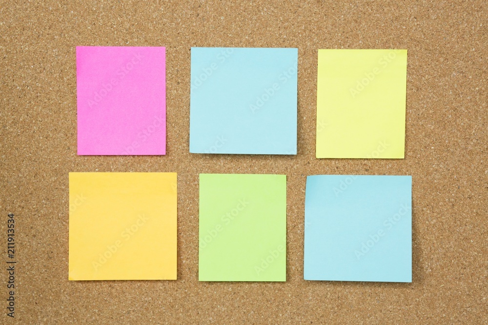 collection of colorful post it. paper note reminder sticky notes on cork bulletin board. empty space for text. collection of colorful post it. paper note reminder sticky notes on cork bulletin board. empty space for text.