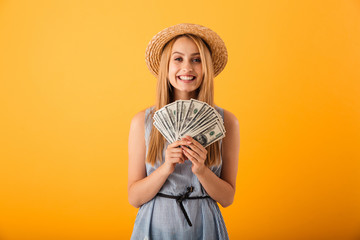 Portrait of a happy young blonde woman in summer hat