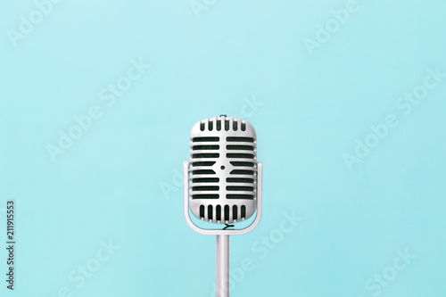 Retro microphone on soft green wall background