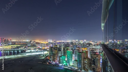 Aerial skyline of Abu Dhabi city centre from above night timelapse photo