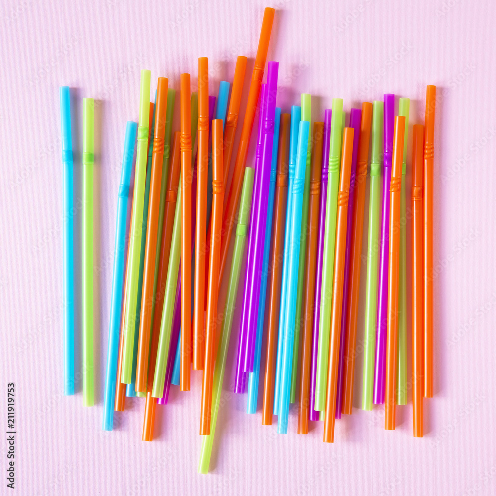 Colorful straws on a pink background Colorful straws on a pink background