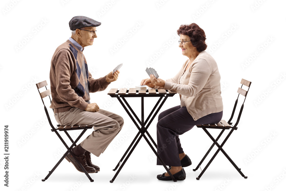Seniors sitting at a table and playing cards Seniors sitting at a table and playing cards