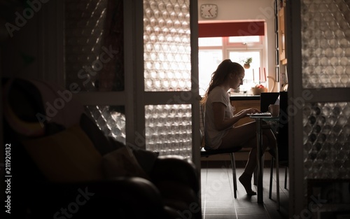 Woman using laptop at home photo