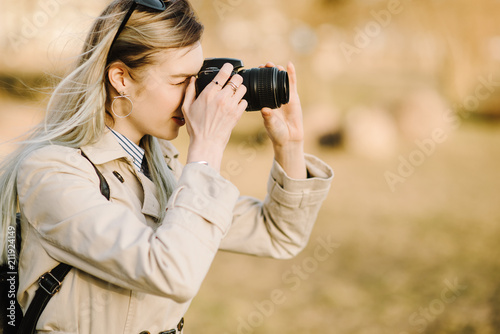 Portrait of a beautiful young blond woman with a camera, lifestyle © Pavel