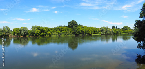 peaceful banks with trees of the Dordogne River in New Aquitaine in the south-west of France  near Bergerac