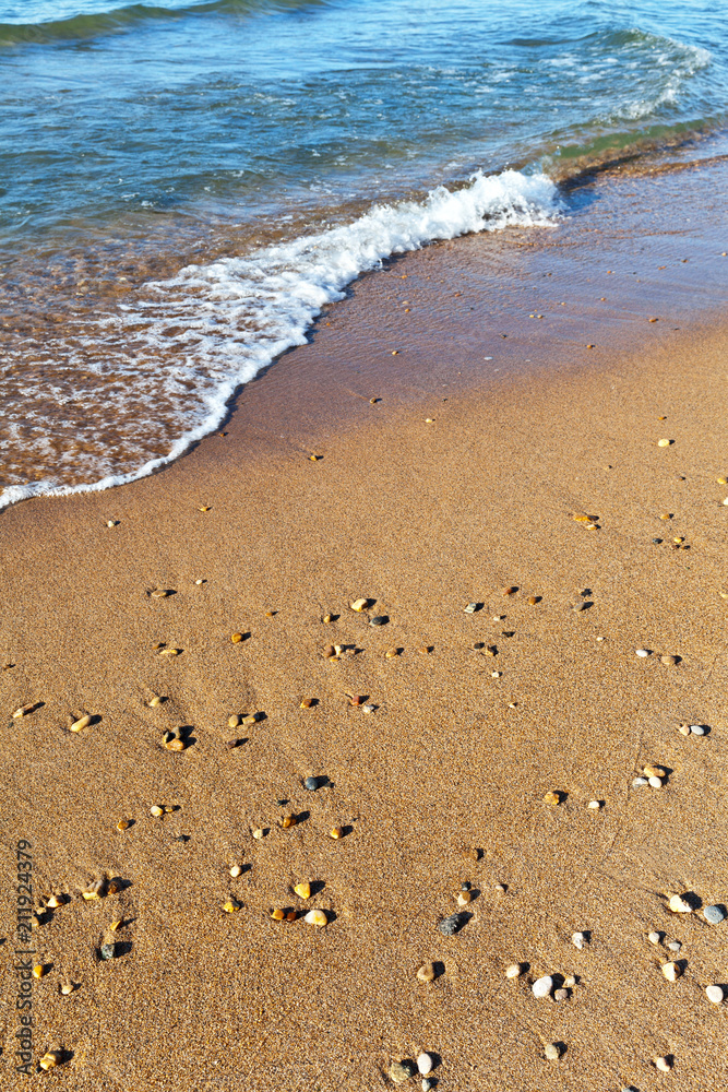The natural background of the sandy coastline in the summer afternoon. Shore of Lake Baikal