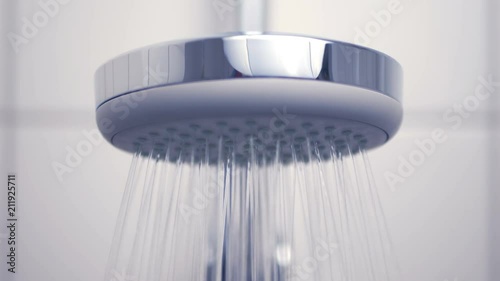 Water running from the modern silver shower head
