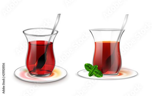 Turkish tea cup with black tea, silver spoon and mint